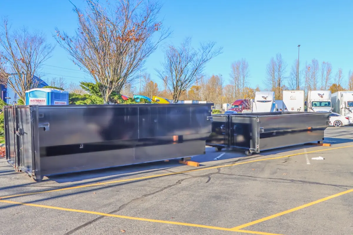 Professional dumpster rental service with roll-off container on residential driveway in Rancho San Diego